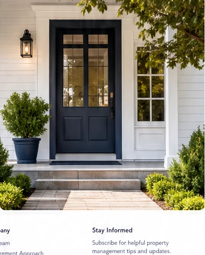 Welcoming residential front entry with black door and greenery